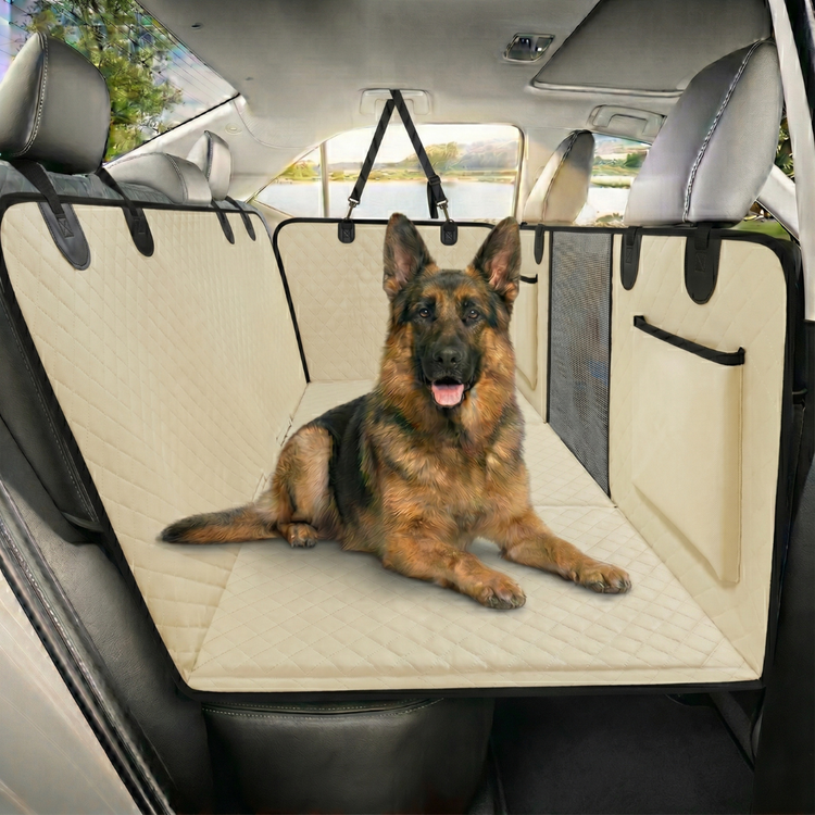 German shepherd lying on the beige seat cover in the back seat of a car