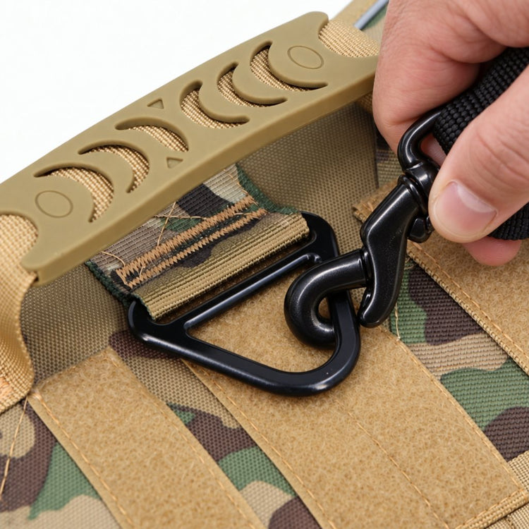 A hand clipping a leash onto the black metal V-ring behind the top handle, with its box stitching in view