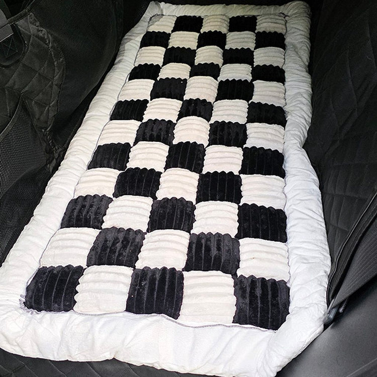 Black Team K9 plush bed on a Black hard bottom seat cover in an SUV