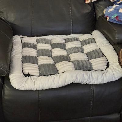 Customer photo from Michele M.: a Gray Team K9 cover on a leather recliner