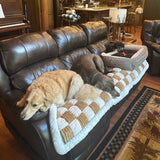 Customer photo from Lisa S.: two dogs resting on a Team K9 couch cover on a leather sofa