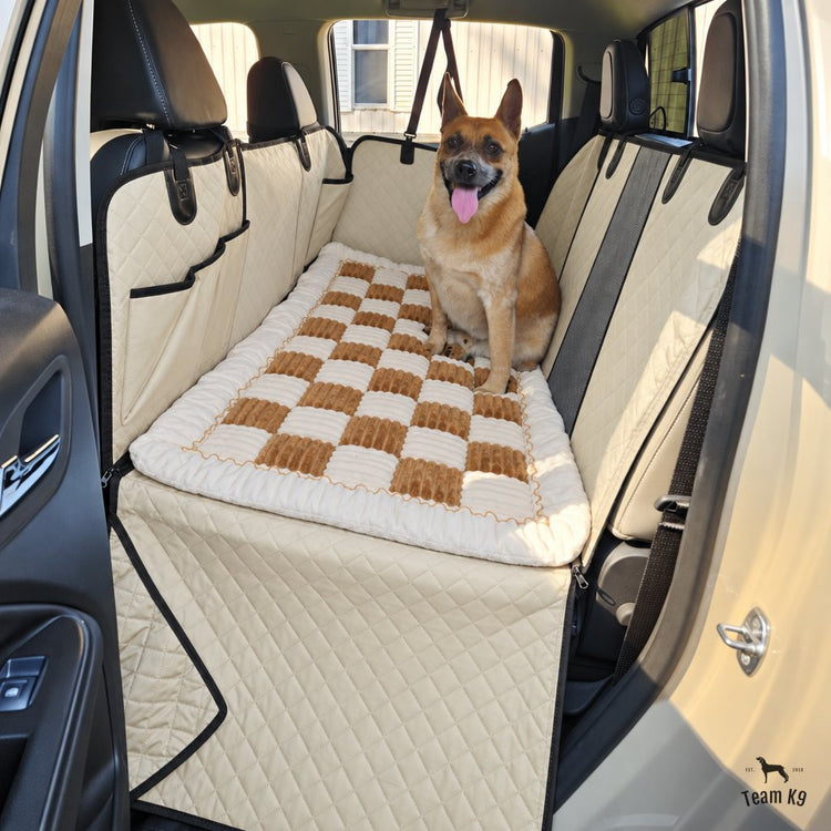 Dog sitting on the plush bed with the seat cover side flap covering the door