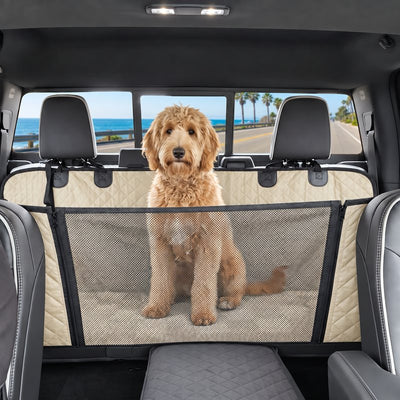 Goldendoodle sitting behind the mesh window of the beige seat cover