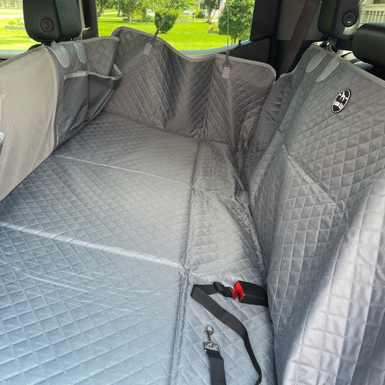 Customer photo from Glenn D.: a Gray Team K9 seat cover with the seat belt buckles coming through