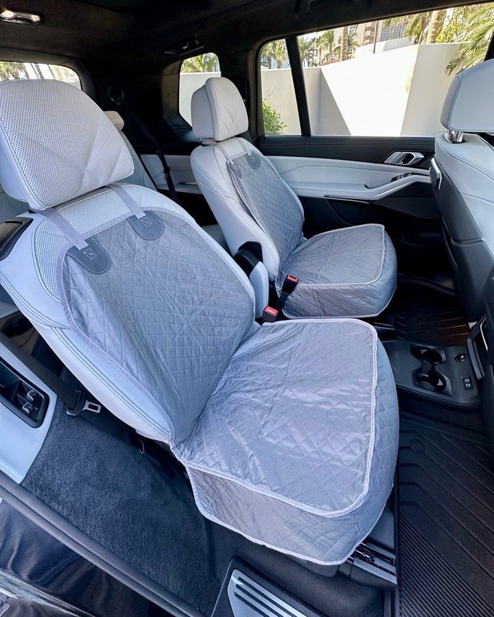Gray Team K9 single-seat covers fitted to the captain's chairs of a BMW X7