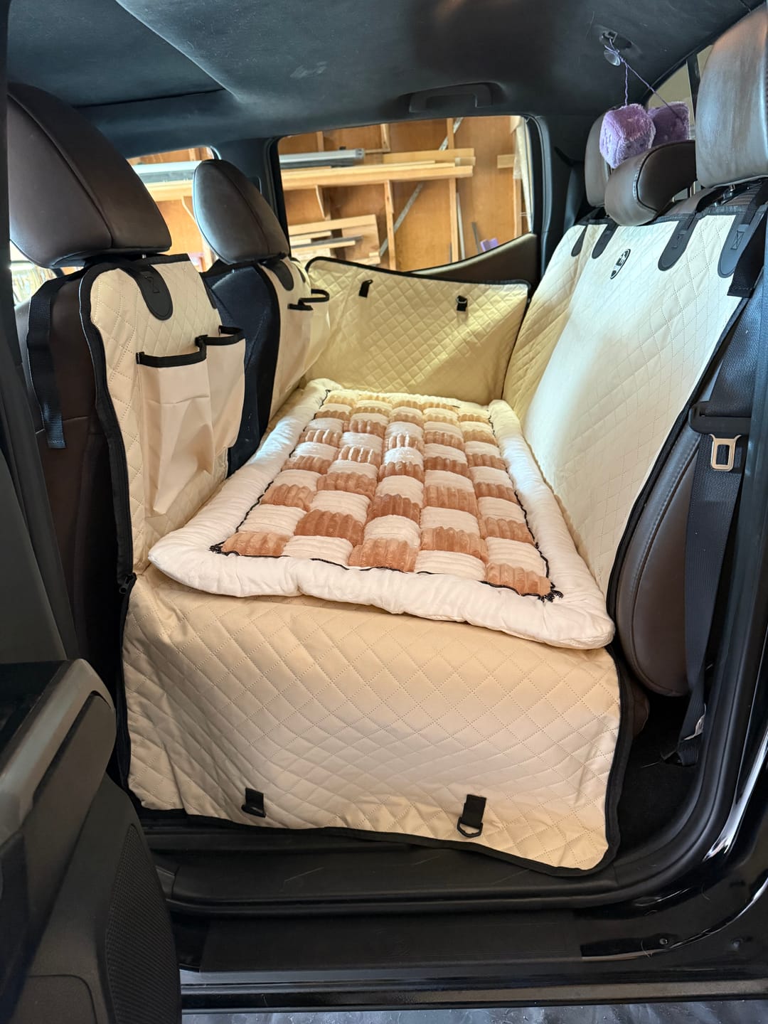 Customer-installed light-colored Team K9 back seat extender with a matching bed