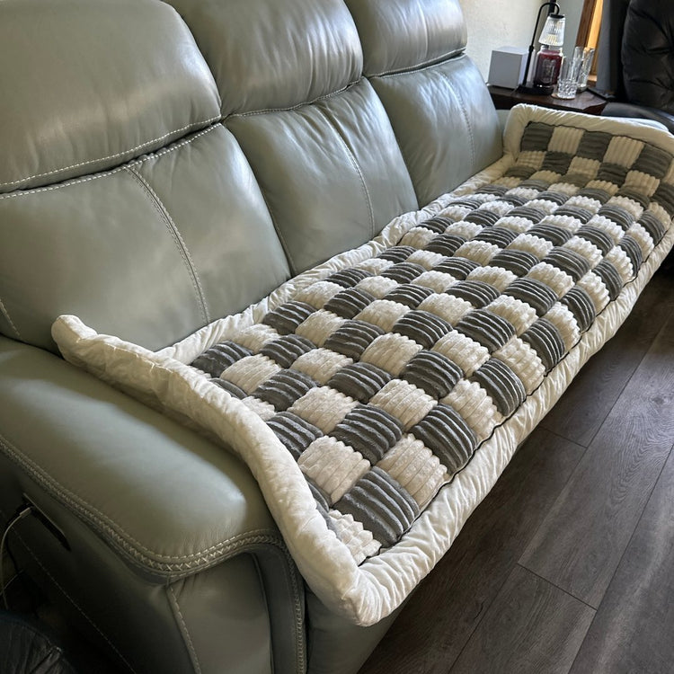 A customer's Gray Team K9 couch cover on a green leather sofa