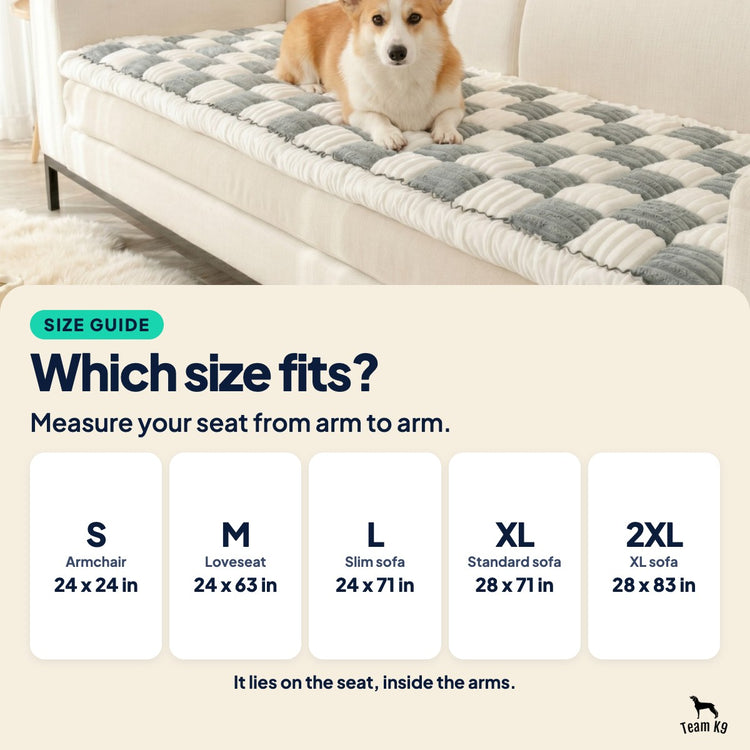 Size guide card over a photo of a corgi on a gray and white Team K9 couch cover: five sizes, armchair 24 x 24 in to XL sofa 28 x 83 in. It lies on the seat, inside the arms.